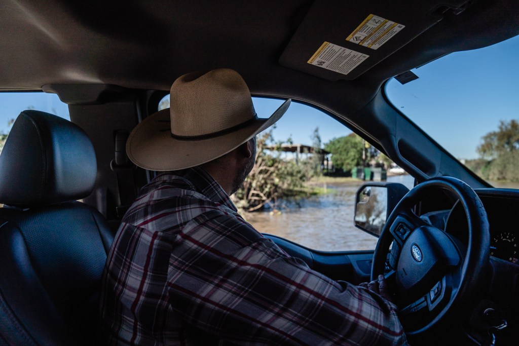 Danny Moreno drives his truck and looks at water leftover from the flooding in San Ysidro on Jan. 21, 2023.