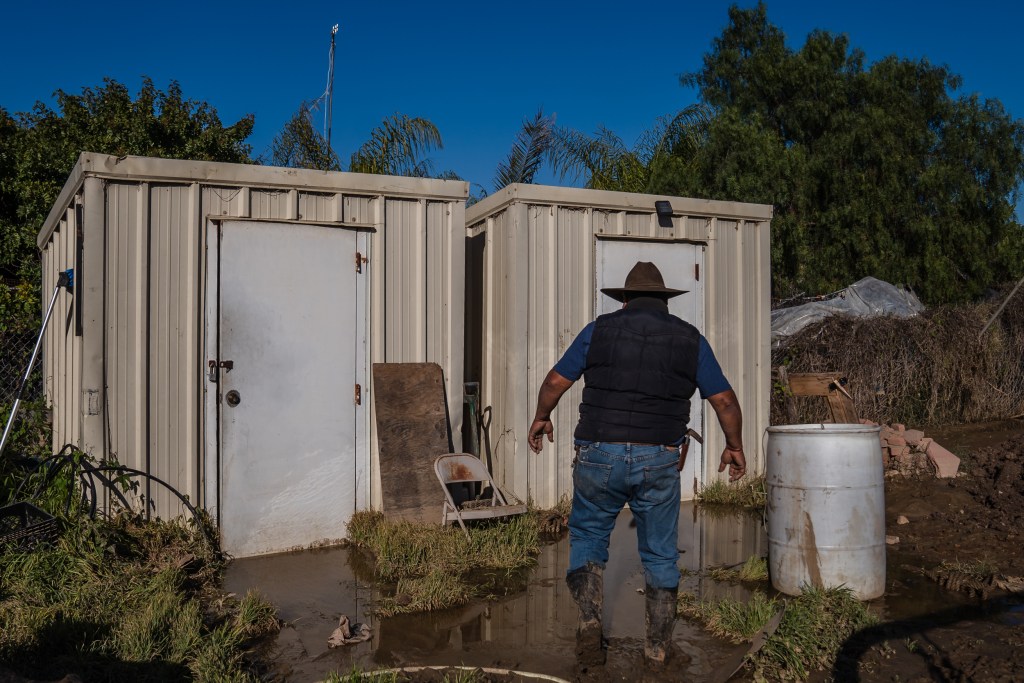 Jim Sandoval of Esperanza Ranch walks to a closet to show that there is still water inside after almost a week from when it got flooded in San Ysidro on Jan. 21, 2023.