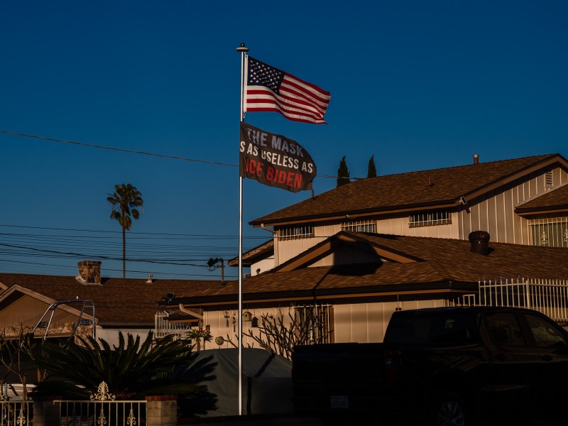 A flag reading "The Mask Is As Useless As Joe Biden" along with the American flag is seen in La Mesa on Jan 21. 2023.