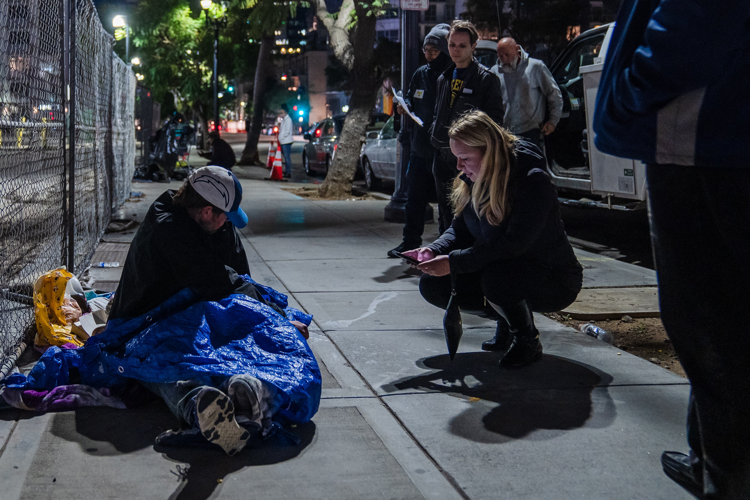 A volunteer speaks to an unhoused individual in downtown during the Point in Time Count on Jan. 26, 2023.
