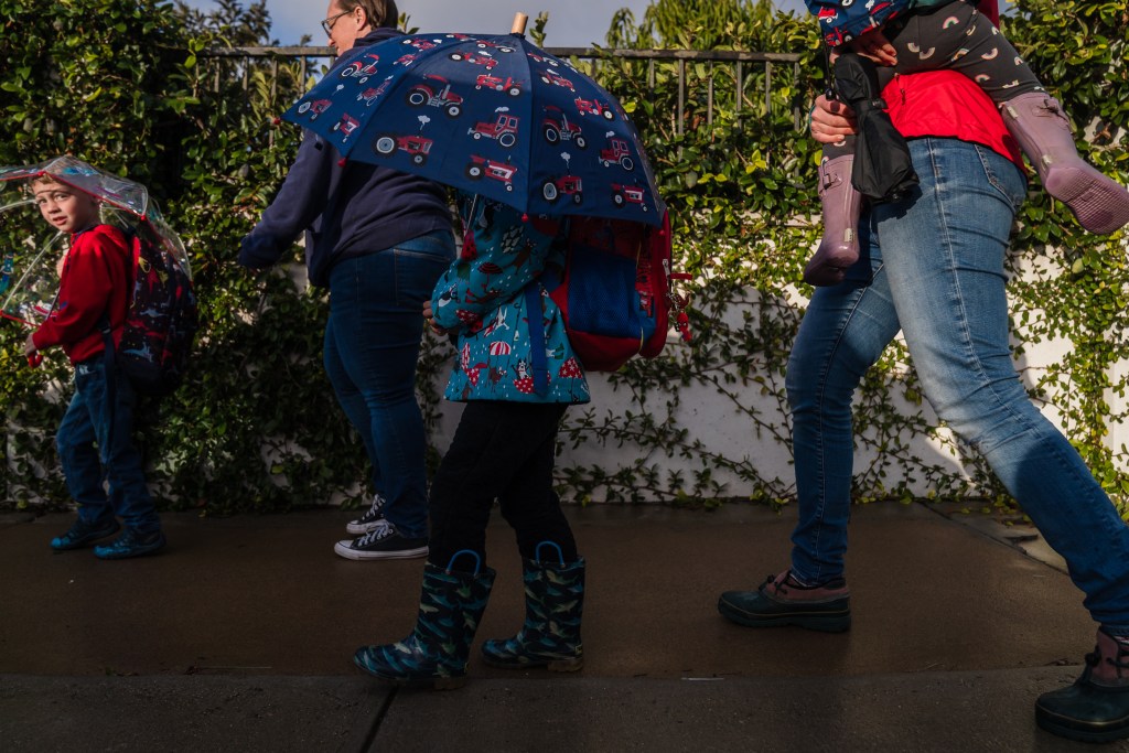 Henry Cole, 5 years old (left) and Rhett Sammons, 4 years old, (center) both UTK students, walk to Stephen C. Foster Elementary School with their mothers on Jan. 30, 2023. /