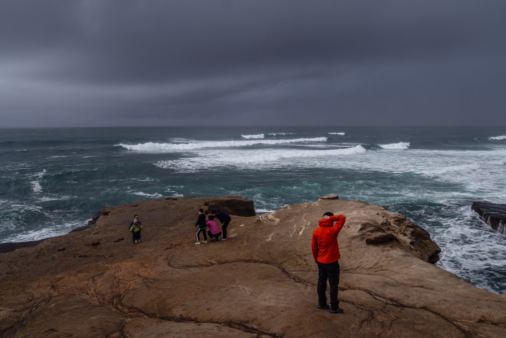 People at Sunset Cliffs in Ocean Beach before it rained on Jan. 15, 2023.