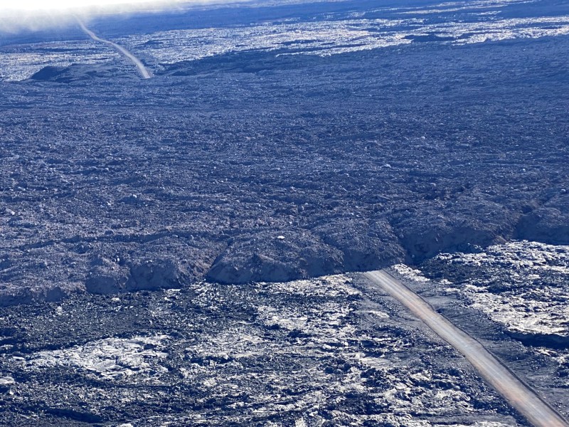 Lava flow at Mauna Loa volcano covers the lone road to a scientific observatory visible from an aerial photo taken Dec. 12, 2022. / National Oceanic and Atmospheric Administration