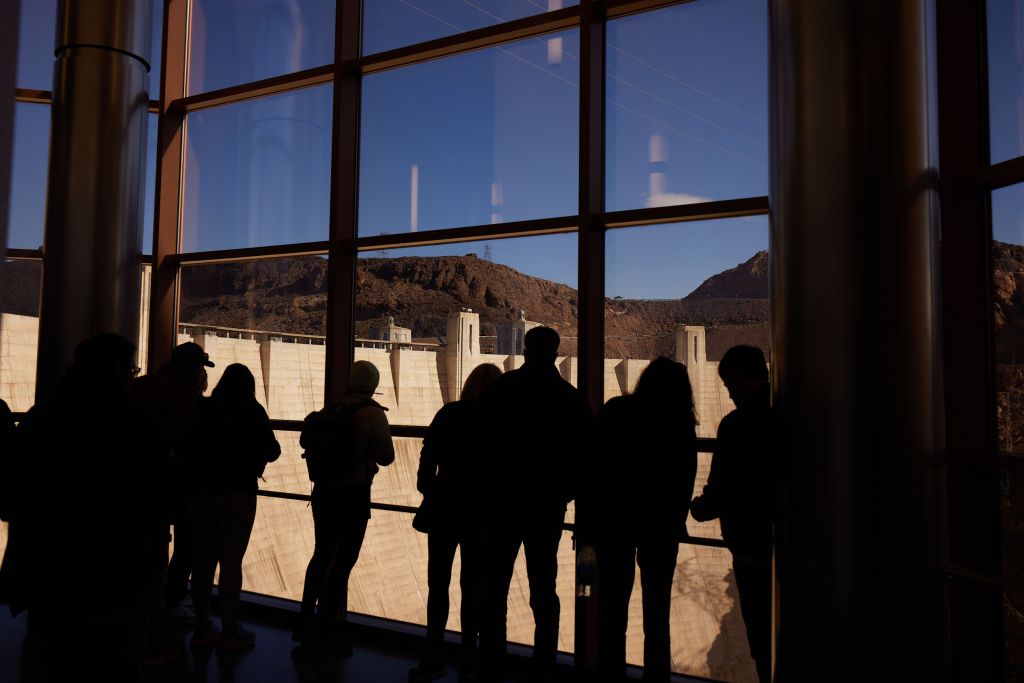 Tourists view Hoover Dam from the Bureau of Reclamation visitor's center on Jan. 31, 2023. / Photo by Joseph Griffin for Voice of San Diego