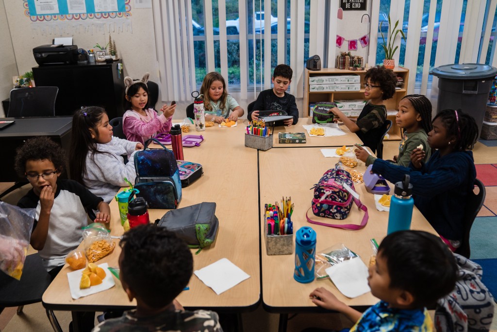 Niños durante el recreo para comer del programa extracurricular de YMCA en la Escuela Primaria Wolf Canyon de Chula Vista. 29 de noviembre de 2022. / Foto por Ariana Drehsler