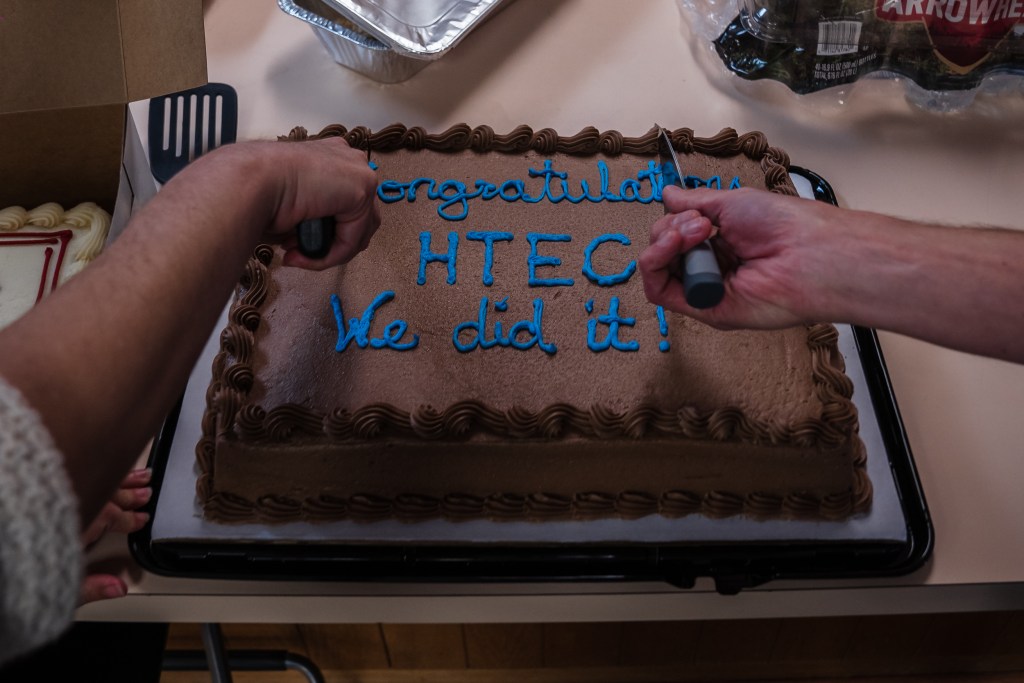 ayden Gore, president and Roxanna Sepehri, vice president of High Tech Education Collective cut the "Congratulations" cake at the San Diego Education Association on Feb. 2, 2023.