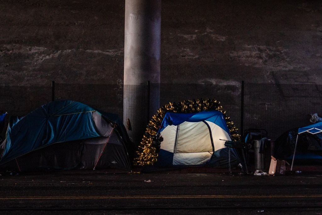 A tent is decorated with balloons under the bridge on Commercial Street in downtown on March 30, 2023.