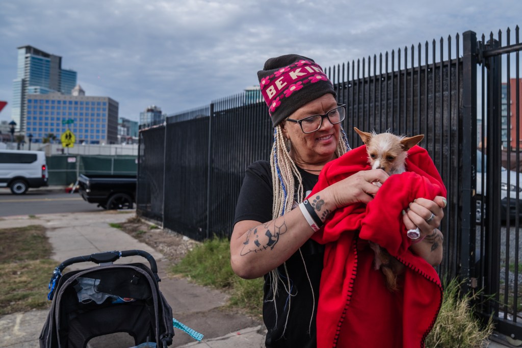 HOLD FOR LISA'S STORY - Julie Tucker, 51 years old with her dog in the East Village on Jan. 9, 2023.