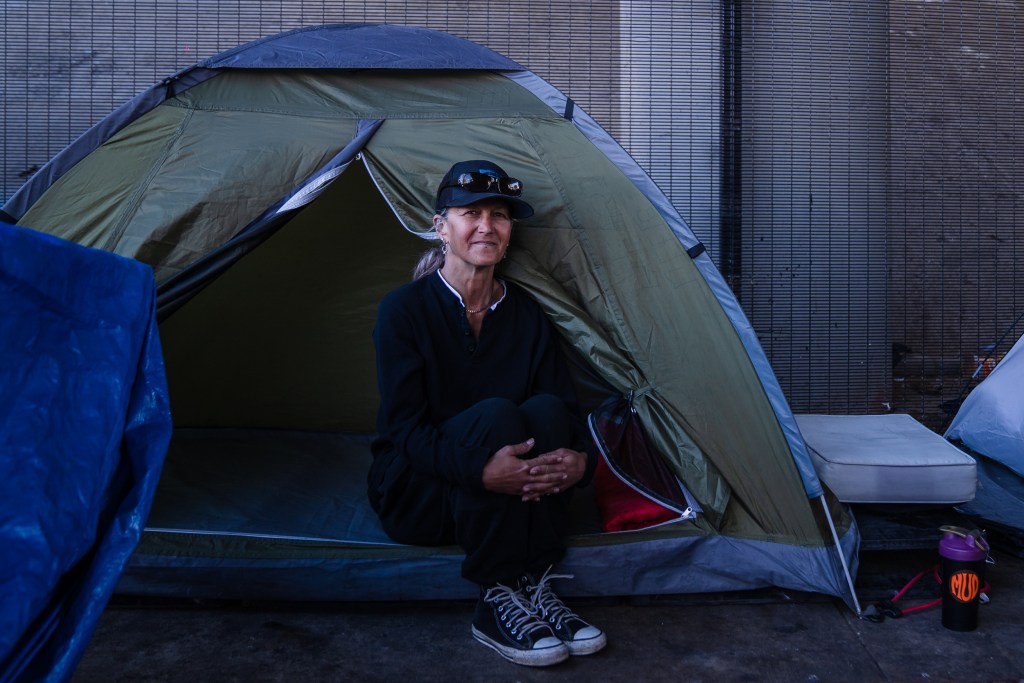 Rachel Hayes, 55 years old sits in her tent off Commercial Street in downtown on Feb. 7, 2023.