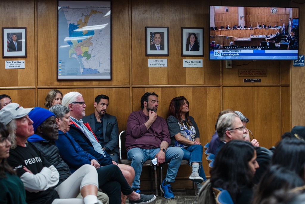 People sit in on a Land Use and Housing Committee meeting in city council chambers in downtown on April 13, 2023.