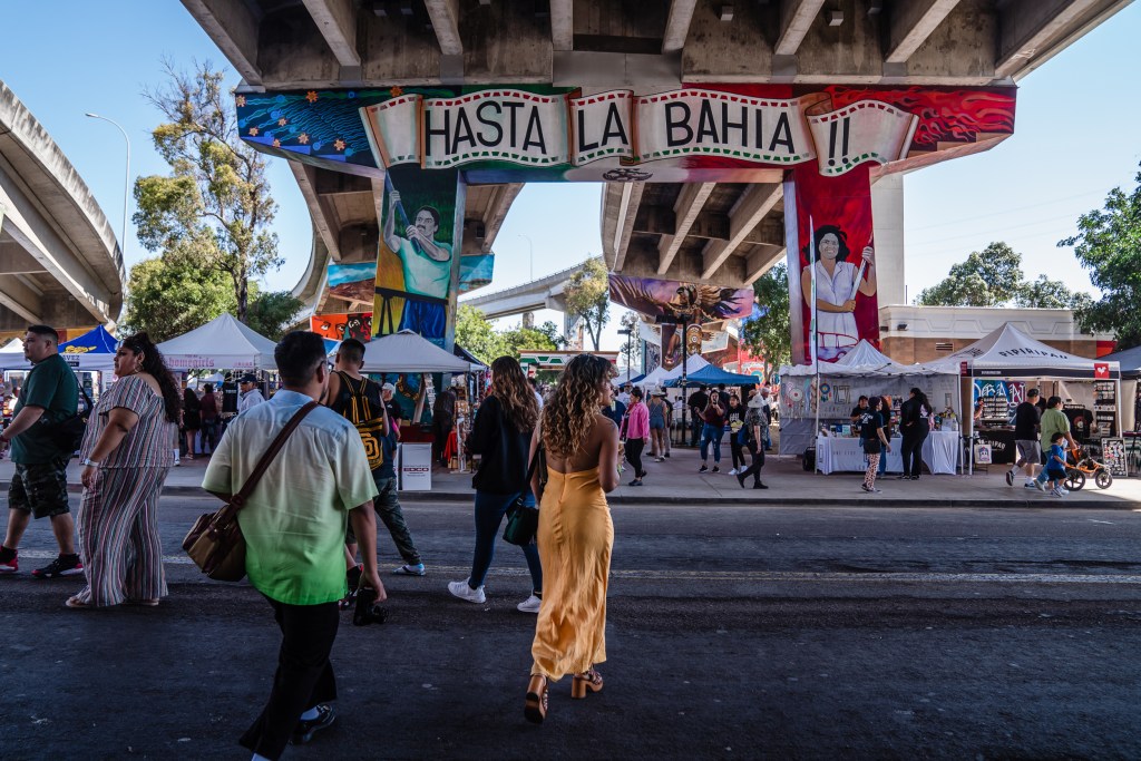 People walk around in Chicano Park in Barrio Logan April 22, 2023.