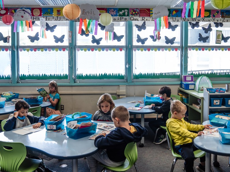 Kindergarten students listen to themselves read during a class assignment at Spreckels Elementary school in University City on April 24, 2023.