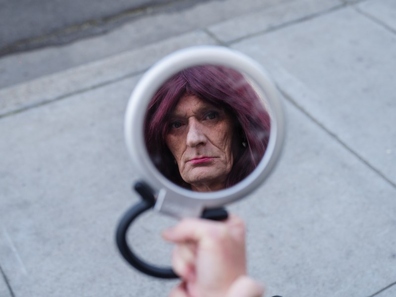 Lisa Pederson looks in the mirror at Alpha Project in the East Village on April 4, 2023.