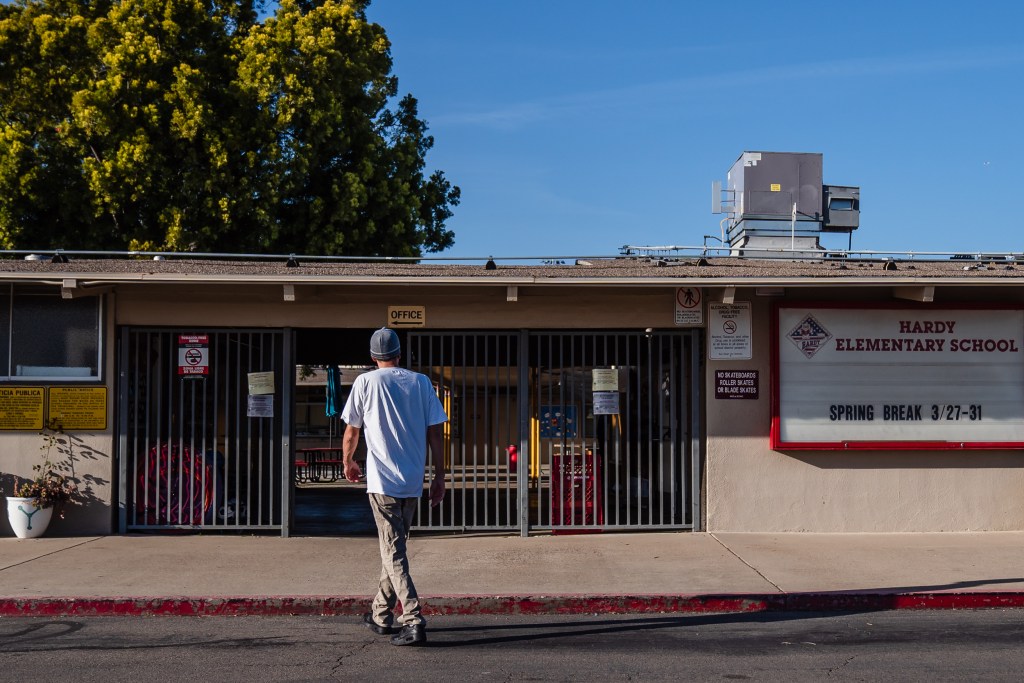 Jared Goossens gets ready to pick up his son Everest from an after school program at Hardy Elementary School in the College area on April 5, 2023.
