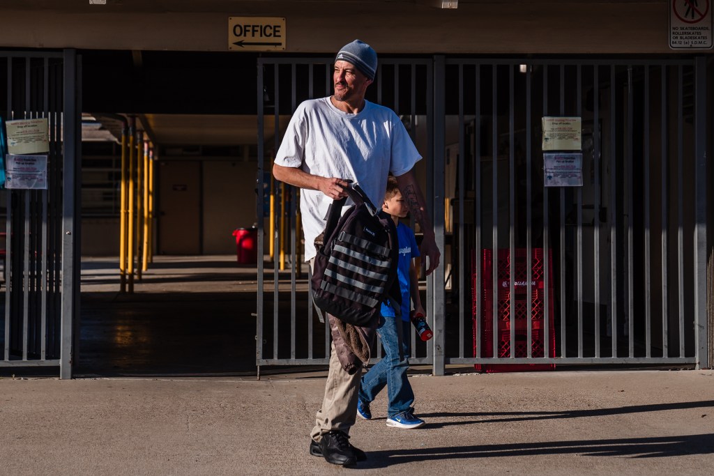 Jared Goossens picks up his son Everest from an after school program at Hardy Elementary School in the College area on April 5, 2023.