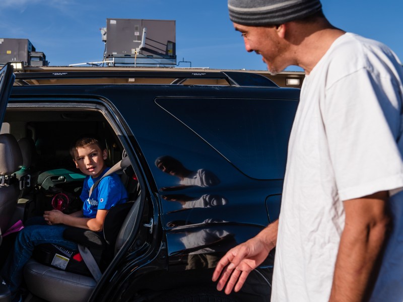 Everest Frits Goosens, 7 years old, talks to his father Jared Goossens at Hardy Elementary School after being picked up from an after school program in the College area on April 5, 2023.