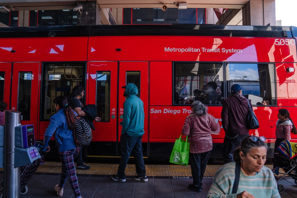 People get ready to board the trolley on 12th and Imperial Avenue in downtown on May 1, 2023.