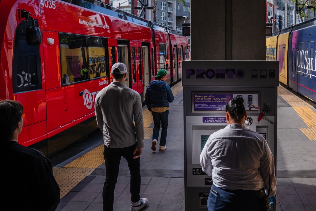A woman stands in front of the PRONTO machine at 12th and Imperial Avenue in downtown on May 1, 2023.