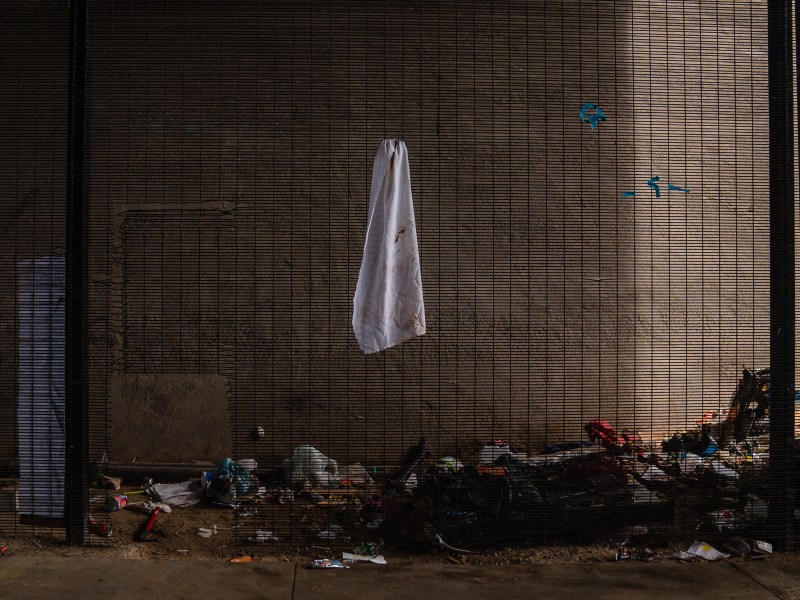 Trash can be seen of what is left from a homeless encampment underneath a freeway on Commercial Street on May 18, 2023.