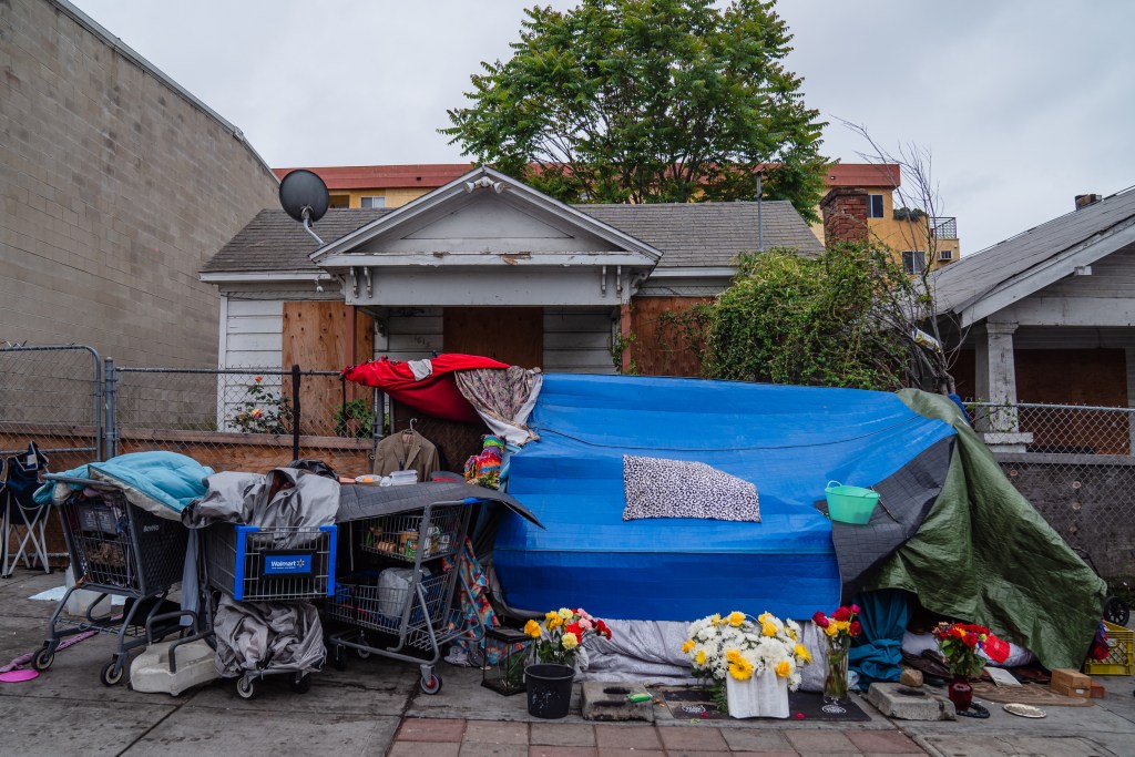 Flowers can be seen in front of a homeless encampment on K Street in the East Village on May 23, 2023.