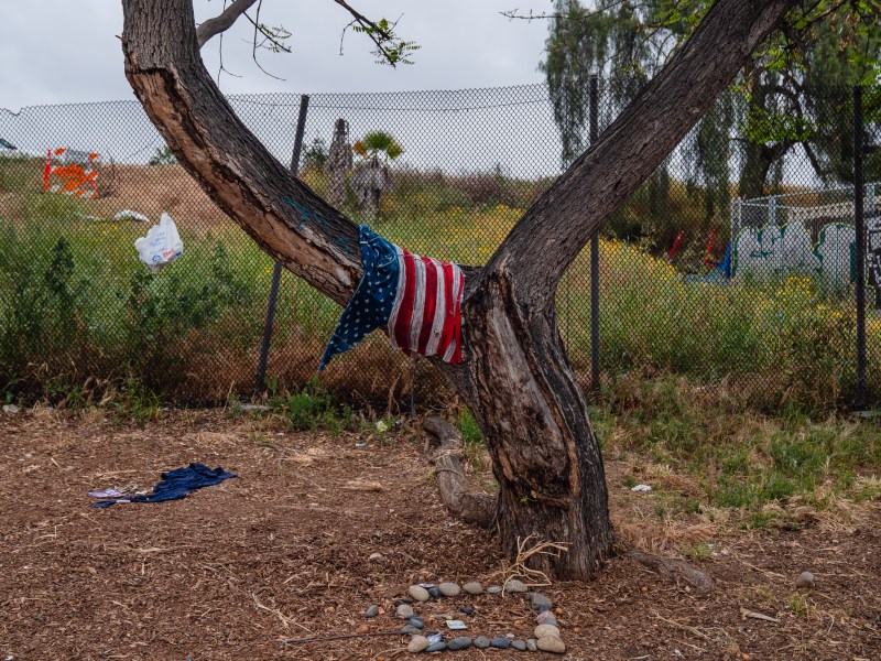 An American Flag hangs on a tree a block away from Neil Good Day Center in the East Village on May 23, 2023.