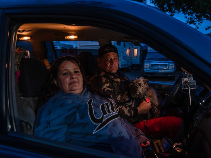 Tami Grobarek and William Pendarvis sit in their broken down car in El Cajon on May 9, 2023. /