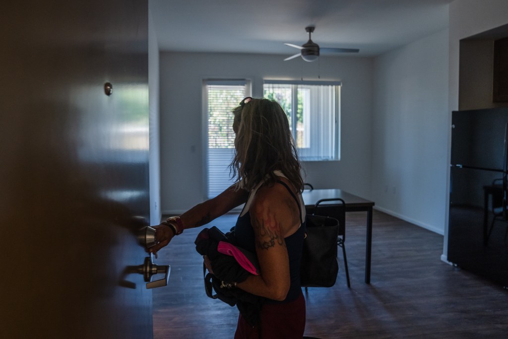 Rachel Hayes walks into her apartment for the first time at Milejo Village in San Ysidro on June 20, 2023. The apartment building is a 65-unit supportive housing community by Jamboree Housing Corporation. Hayes has been homeless since 2012.