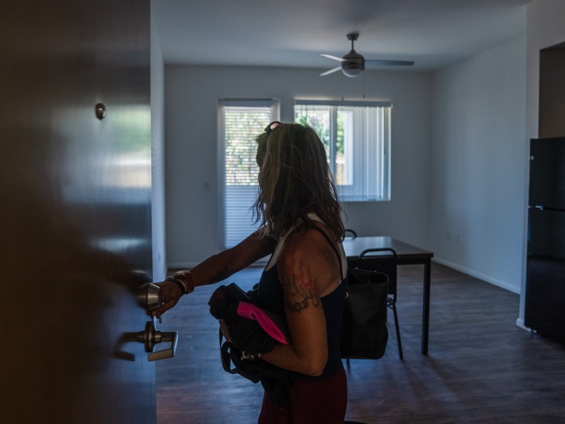 Rachel Hayes walks into her apartment for the first time at Milejo Village in San Ysidro on June 20, 2023. The apartment building is a 65-unit supportive housing community by Jamboree Housing Corporation. Hayes has been homeless since 2012.