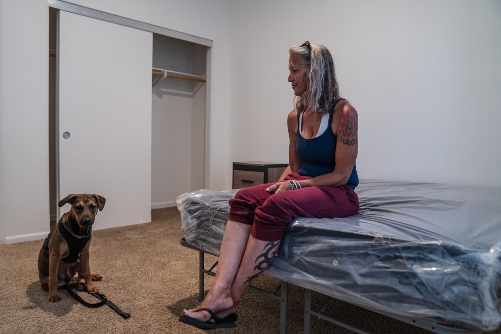 Rachel Hayes with her dog Nino in her new apartment in San Ysidro on June 20, 2023.