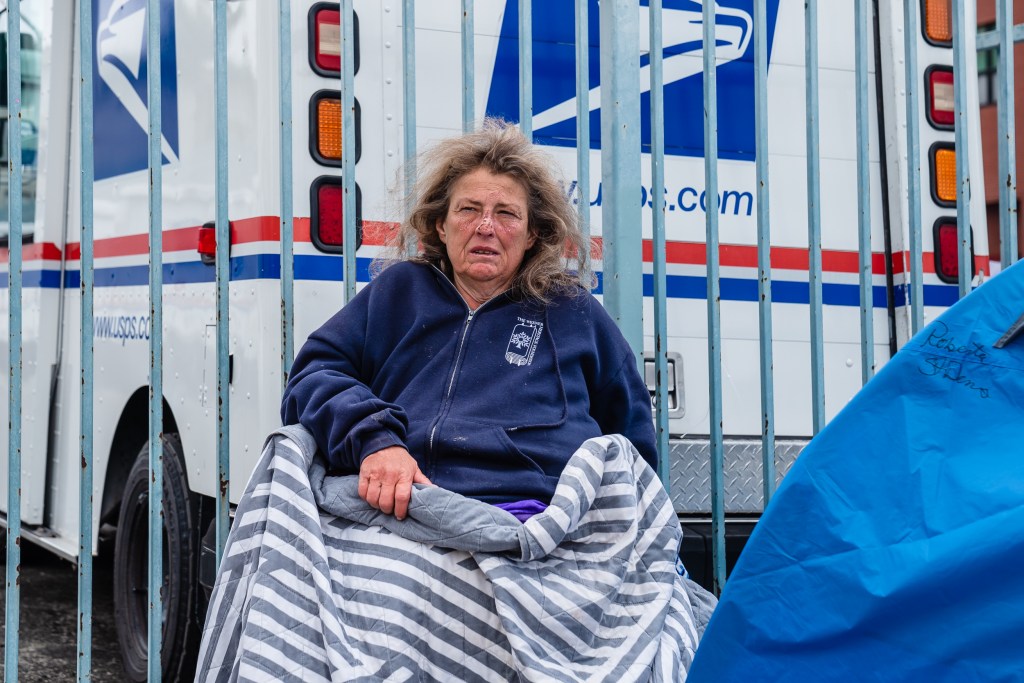 Roberta St. Denis sits in her walker near the post office in downtown on June 1, 2023.