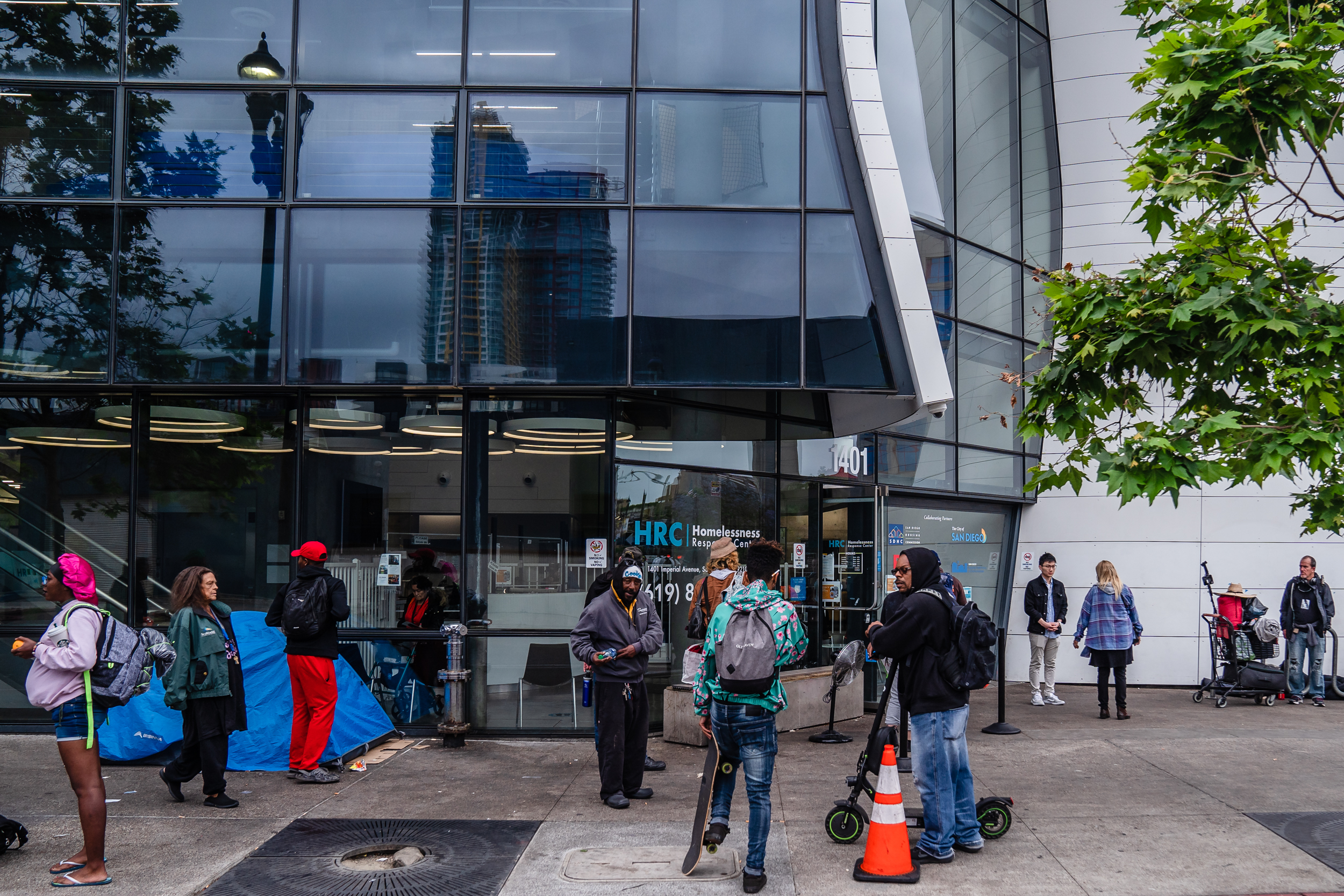 People that are unhoused stand outside of the Homelessness Response Center in the East Village waiting to see if they will be able to stay in shelter on June 5, 2023.