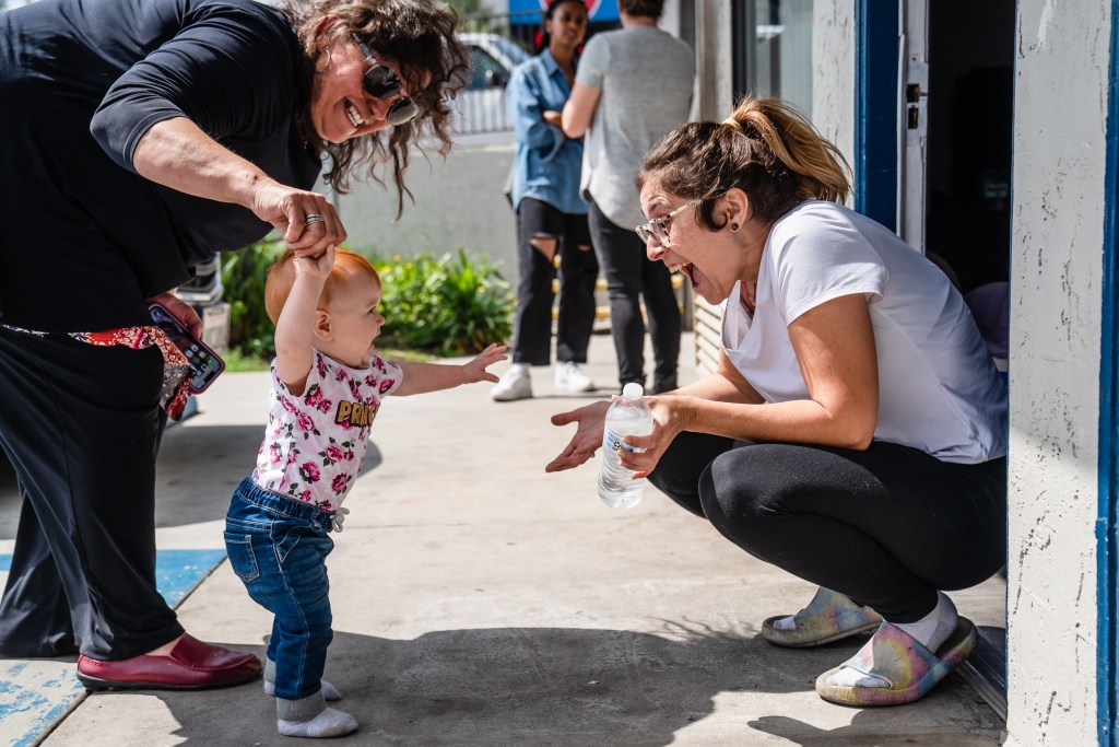 Vanessa Graziano holds Penelope Shephard's hand as she looks at her mother, Jessica Shephard at the Motel 6 in Carlsbad on June 5, 2023.