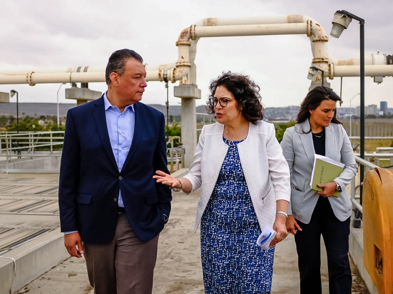 International Boundary and Water Commission leader Maria Elena Giner talks with Sen. Alex Padilla atop the non-functioning primary treatment system at the South Bay International Wastewater Treatment Plant. EPA Regional 9 director Martha Guzman looks into the primary treatment vat.