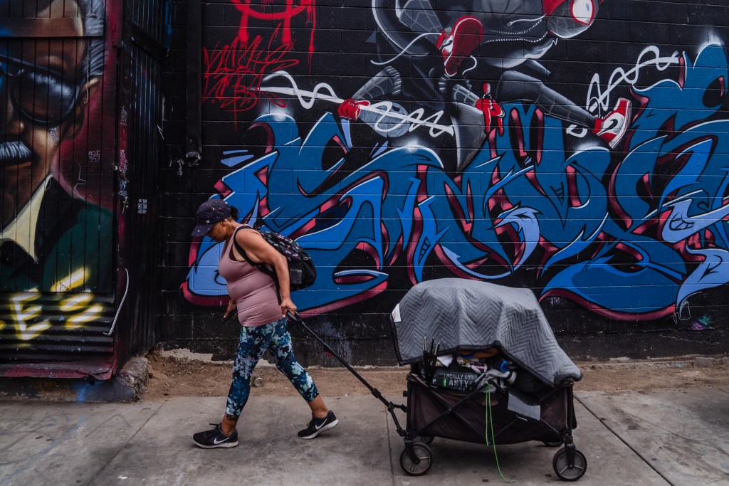 Mercedes Ortega moves some of her belongings from Commercial and 15th Street to another location in the outskirts of downtown on July 31, 2023.