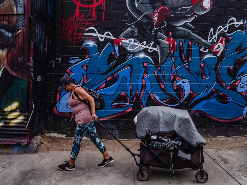 Mercedes Ortega moves some of her belongings from Commercial and 15th Street to another location in the outskirts of downtown on July 31, 2023.
