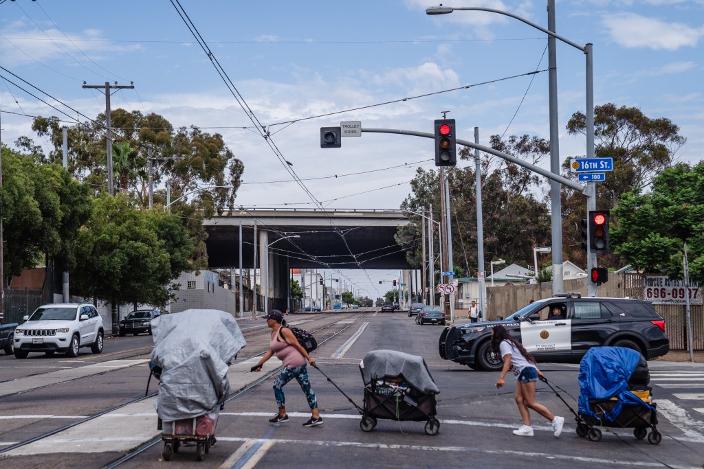 Mercedes Ortega (left) moves some of her belongings from Commercial and 15th Street to another location in the outskirts of downtown on July 31, 2023.