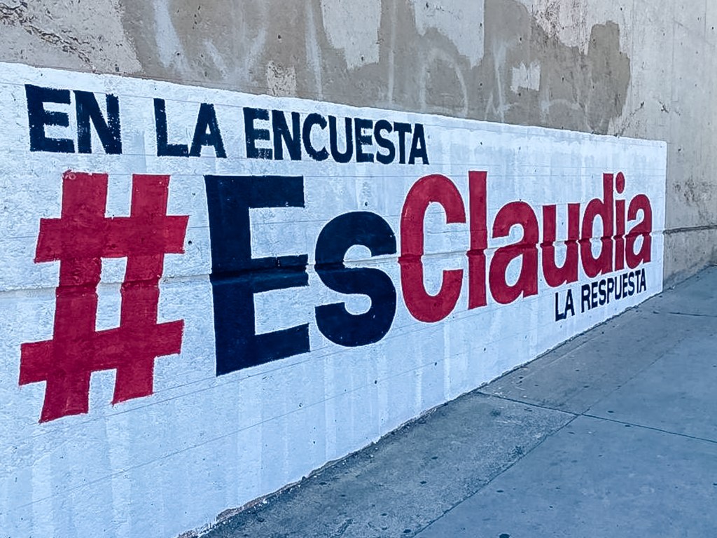A campaign sign for Claudia Scheinbaum, a presidential hopeful from President Andres Manuel Lopez Obrador's MORENA Party, is painted on the side of a building off of Tijuana's Diaz Ordaz Boulevard. Though the campaign season for Mexico's June 2024 election won't officially open until September, campaign signs for presidential contenders are starting to appear in Tijuana.