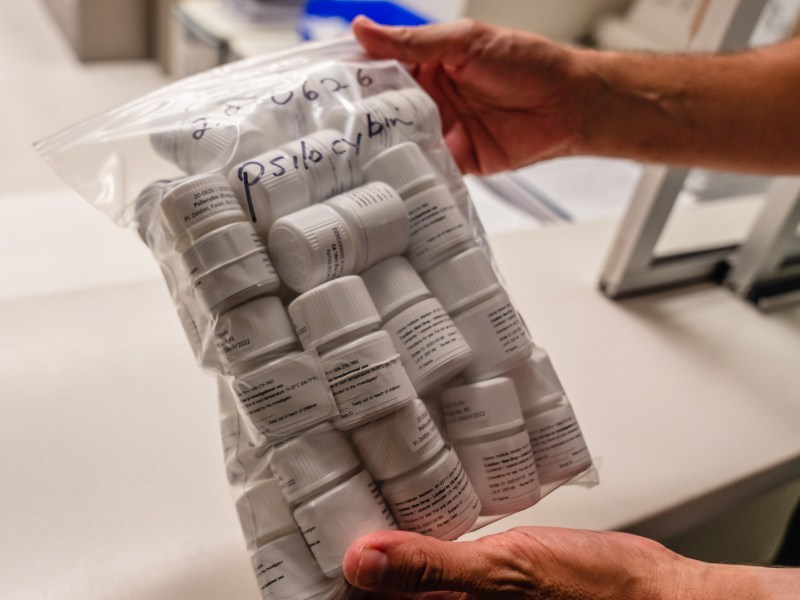 Fadel Zeidan, Ph.D., holds a bag of psilocybin at the Altman Clinical and Translational Research Institute at the University of California, San Diego in La Jolla on Aug. 3, 2023.