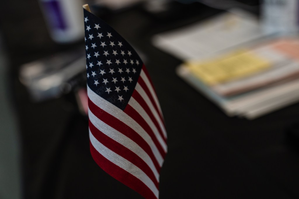 A small American flag sits on a table at the City Heights Recreation Center polling station on Aug. 15, 2023.