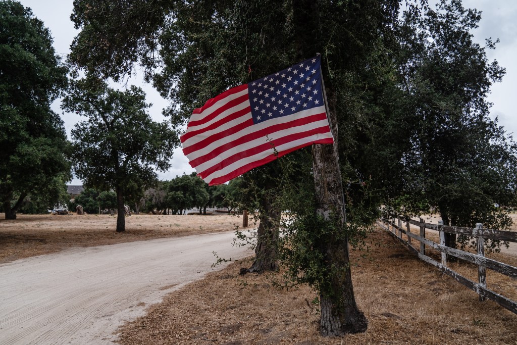 An American flag blows in the wind off Highway 94 near Jacumba, Calif. on Aug. 19, 2023.
