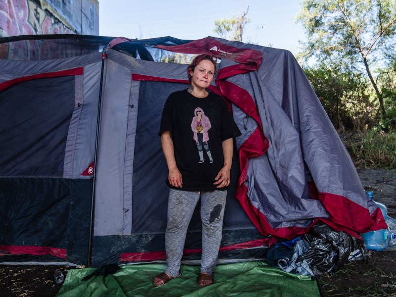 Claudia Alvarez, 33 in front of her tent in Mission Valley's riverbed on Aug. 22 2023. Alvarez has been homeless since she was 17 years old.