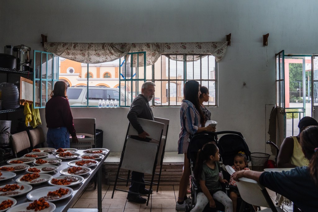 Migrants staying at Refugio Salesiano Don Bosco in Tijuana on Aug. 24, 2023 get ready to have breakfast. A shelter for women and children.