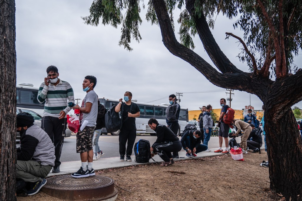 Asylum seekers dropped at off near the Iris Avenue Trolley Station in Otay Mesa on Sept. 14, 2023. After being dropped off, some were trying to figure out how they could reach out to friends and family to meet them or be picked up.