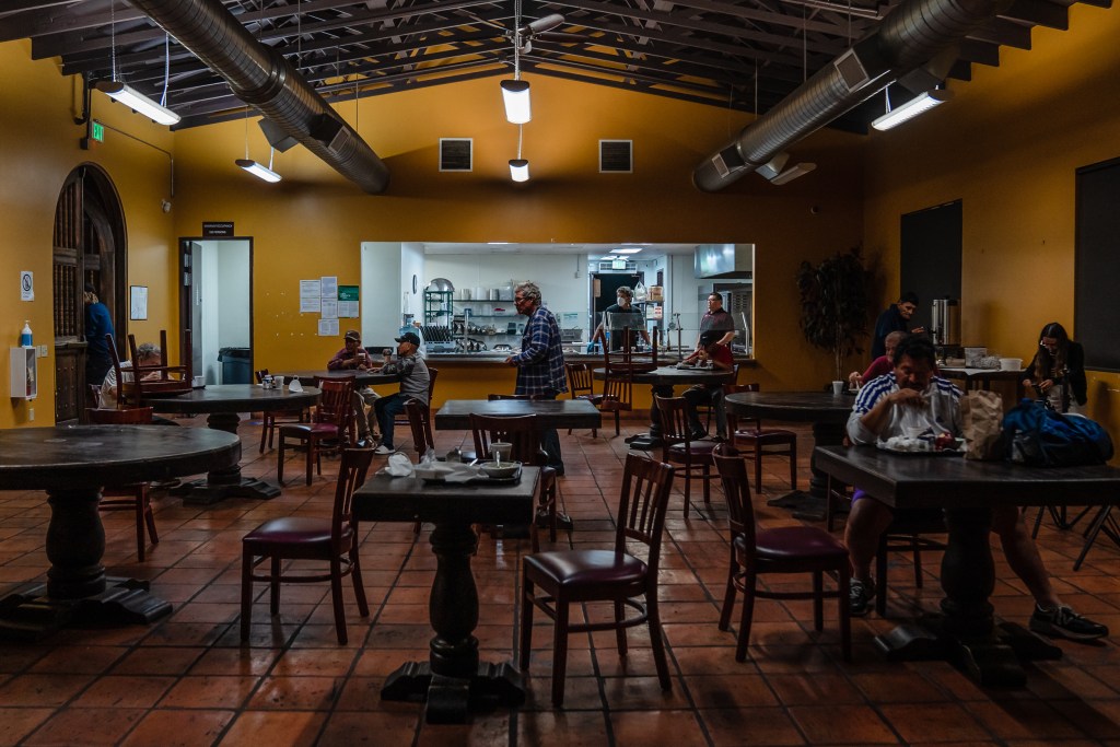 Farmers and other clients staying at Catholic Charities La Posada have breakfast early morning in Carlsbad on Sept. 21, 2023.