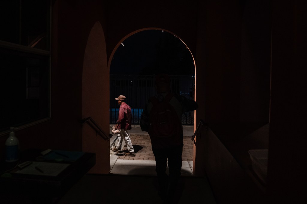 Antonio Jacobo and another farmer leaving Catholic Charities La Posada in the early morning for work in Carlsbad on Sept. 21, 2023.