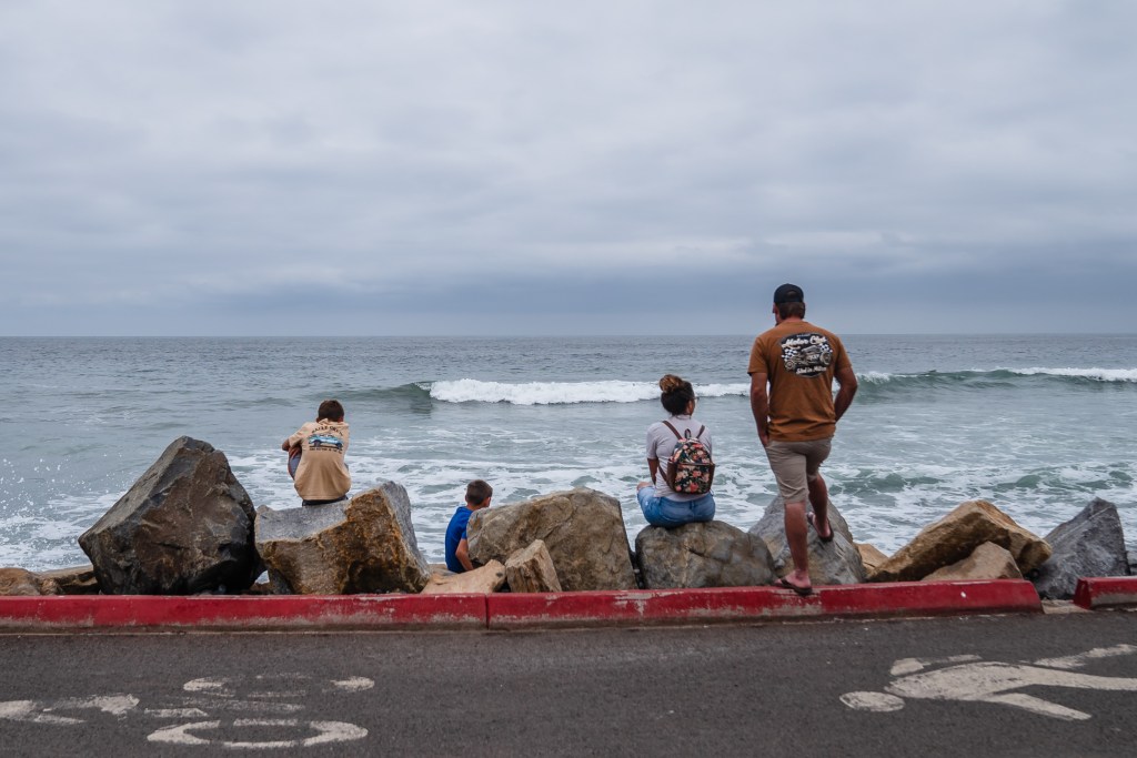 People watch the waves in Oceanside on Sept. 5, 2023.