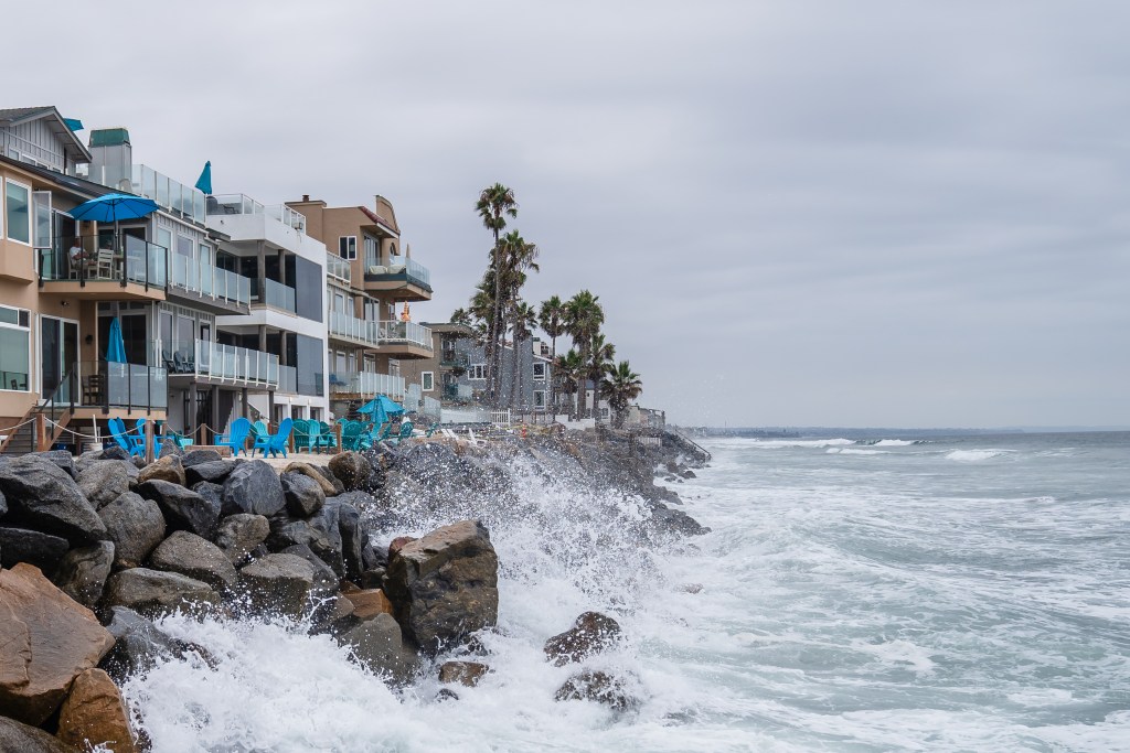 Waves crash against the rocks during hid tide in Oceanside on Sept. 5, 2023.