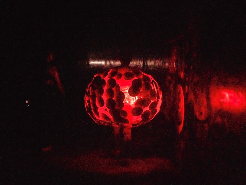 A woman walks through a tunnel wearing a costume to an underground rave in San Diego on Oct. 21, 2023. The location of the rave was well hidden among the city’s tunnels. It was a long and dark walk to get inside.