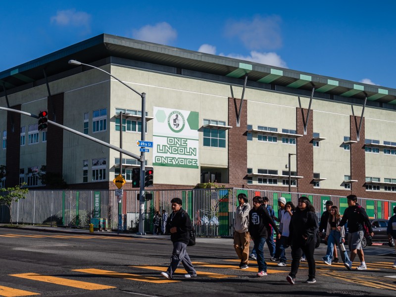 Students cross the street in front of Lincoln High School on Oct. 23 2023.