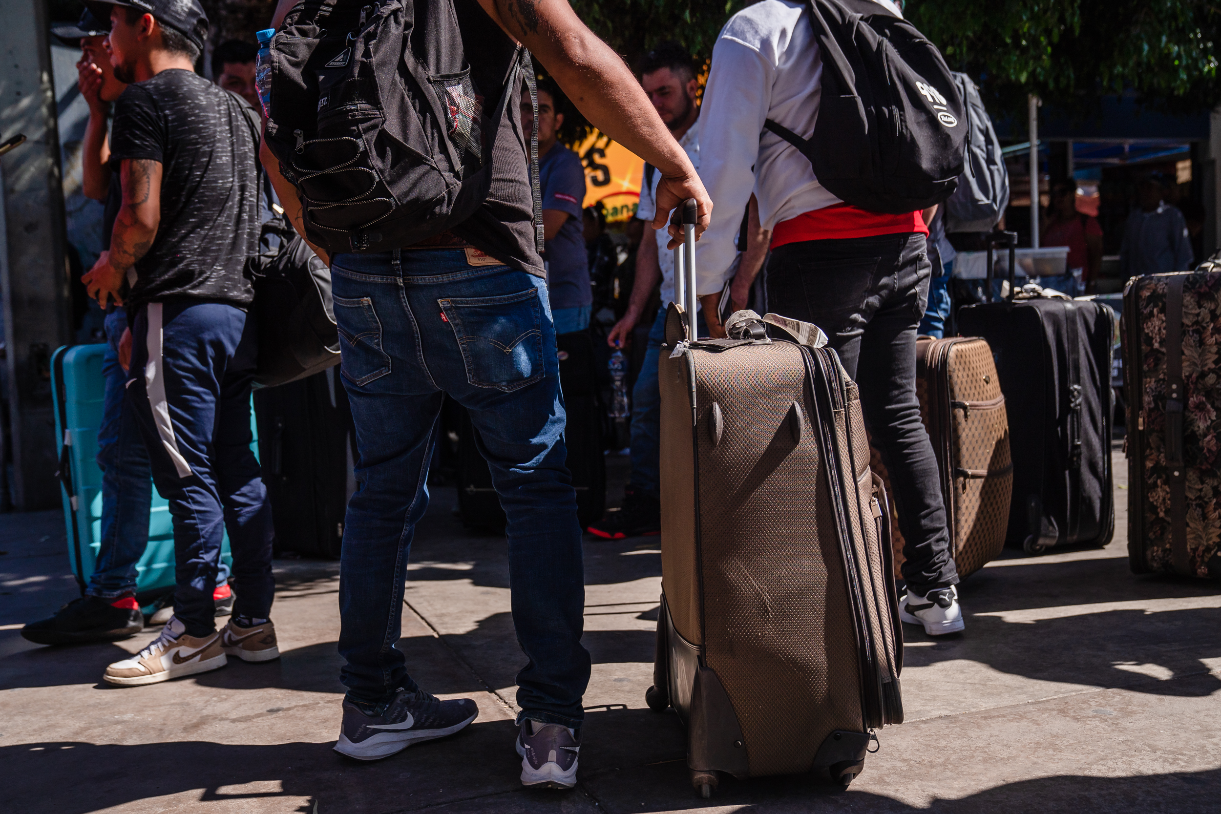 A group of Mexican farmworkers with H2A visas prepare to cross at the San Ysidro border to work in the U.S. on Oct. 6, 2023.